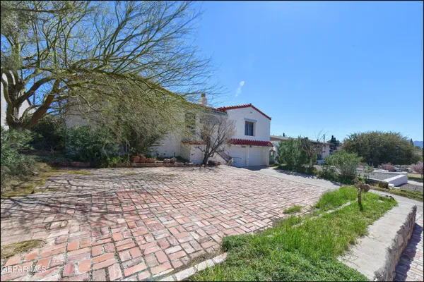 a pathway of a house with a yard
