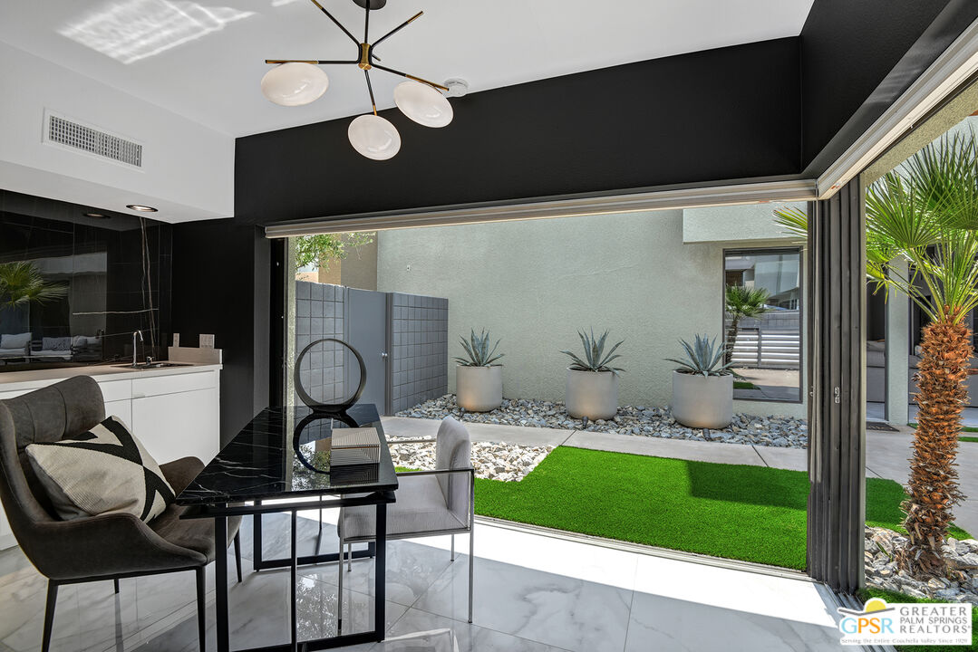 1508 East Baristo Road Palm Springs, CA 92262 - Photo 16 of 62 a living room with furniture and a floor to ceiling window