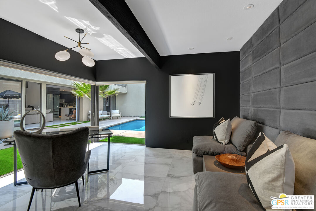 1508 East Baristo Road Palm Springs, CA 92262 - Photo 19 of 62 a living room with furniture and a floor to ceiling window