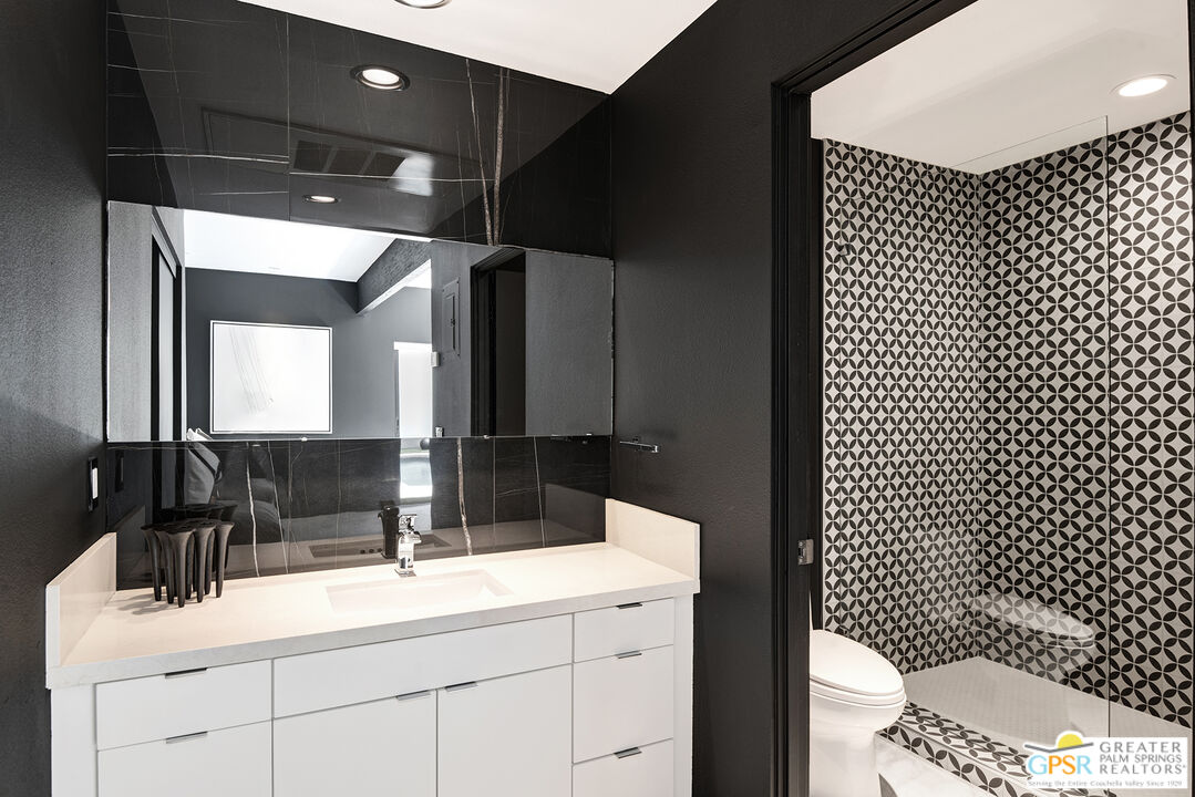 1508 East Baristo Road Palm Springs, CA 92262 - Photo 22 of 62 a bathroom with a sink a toilet and a mirror