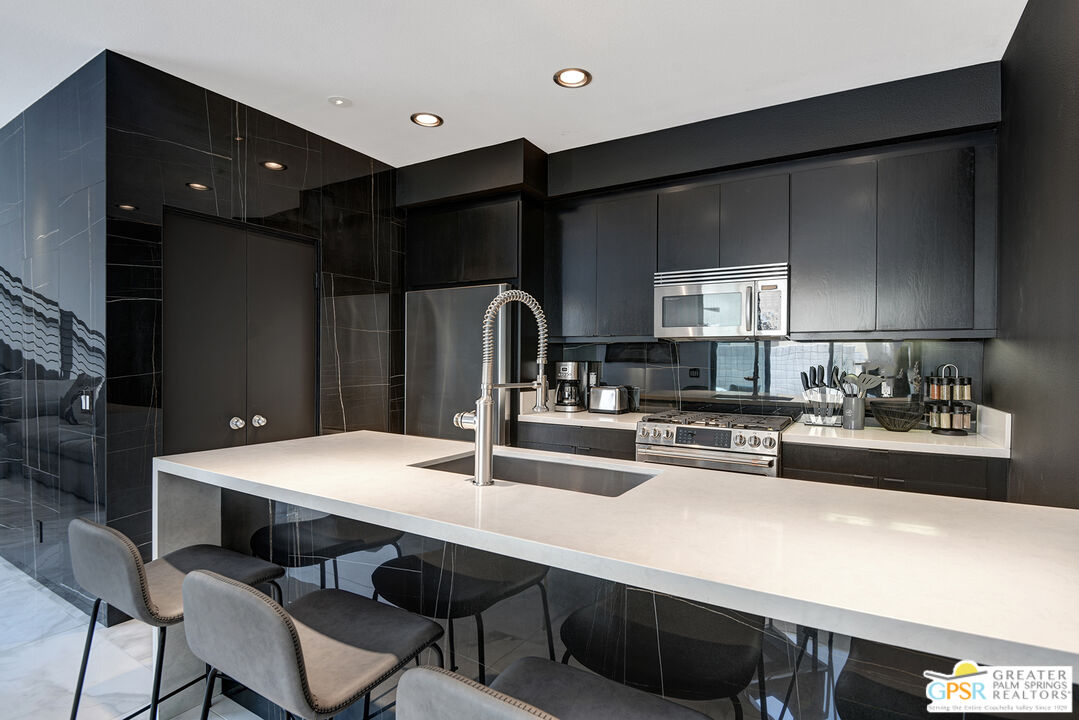 1508 East Baristo Road Palm Springs, CA 92262 - Photo 33 of 62 a kitchen with a sink cabinets and wooden floor