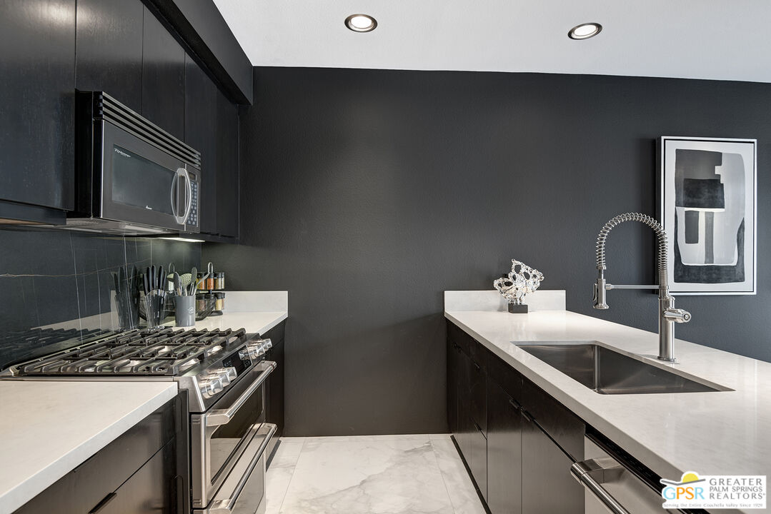 1508 East Baristo Road Palm Springs, CA 92262 - Photo 37 of 62 a kitchen with stainless steel appliances a sink stove and microwave