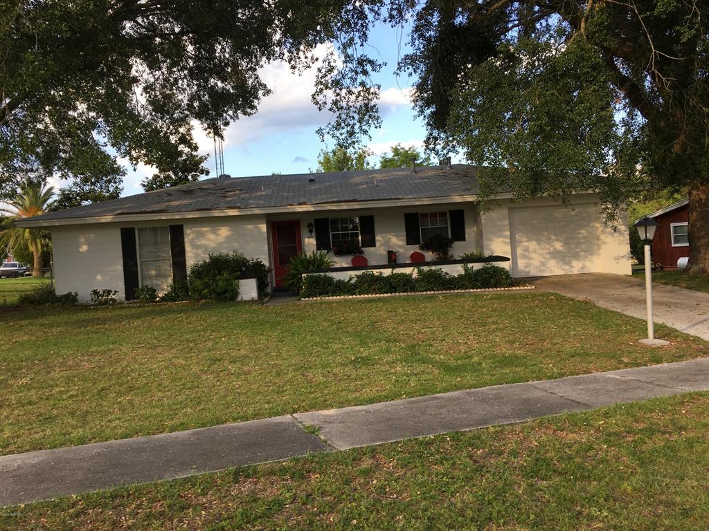 3841 Southwest 143rd Ln Road Ocala, FL 34473 - Photo 1 of 1 a front view of house with yard and trees
