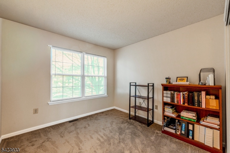 159 West Market Street Newark, NJ 07103 - Photo 12 of 18 a living room with a book shelf and a book shelf