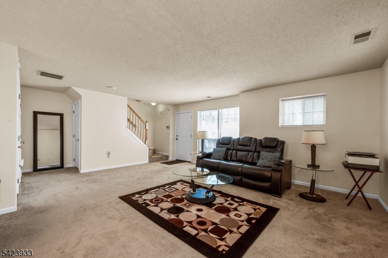 159 West Market Street Newark, NJ 07103 - Photo 4 of 18 a living room with furniture and a rug