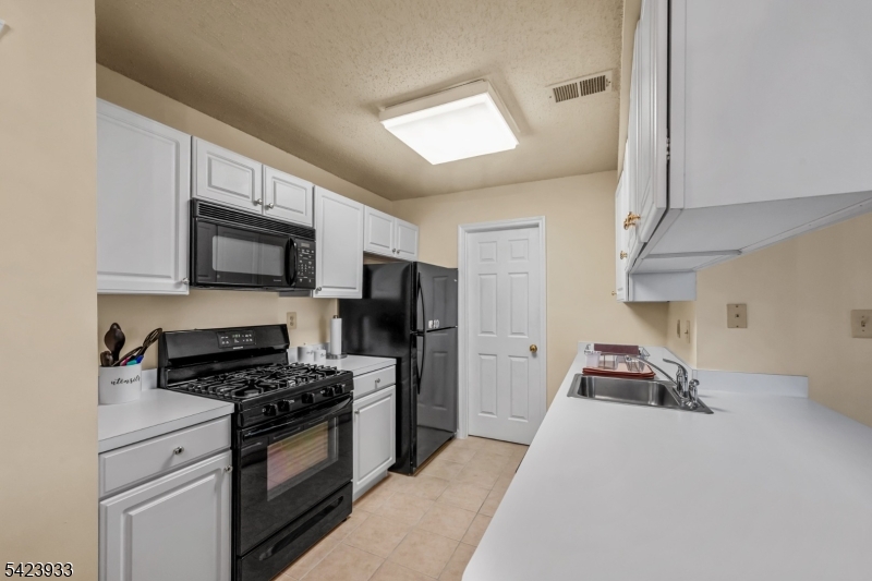 159 West Market Street Newark, NJ 07103 - Photo 7 of 18 a kitchen with cabinets and appliances