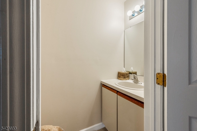 159 West Market Street Newark, NJ 07103 - Photo 8 of 18 a bathroom with a sink and a mirror
