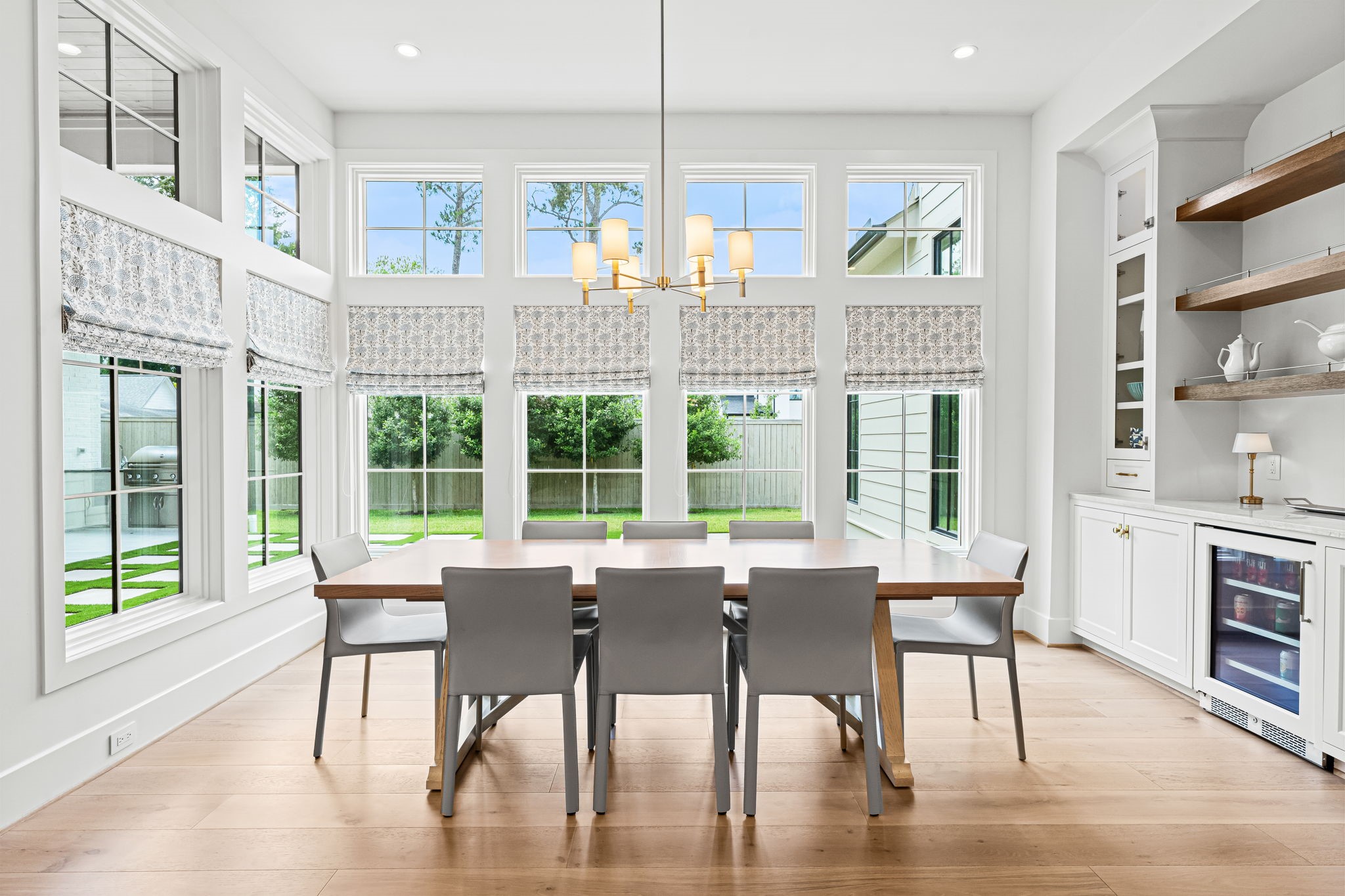 8722 Lupton Lane Houston, TX 77055 - Photo 15 of 44 a dining room with furniture a chandelier and wooden floor