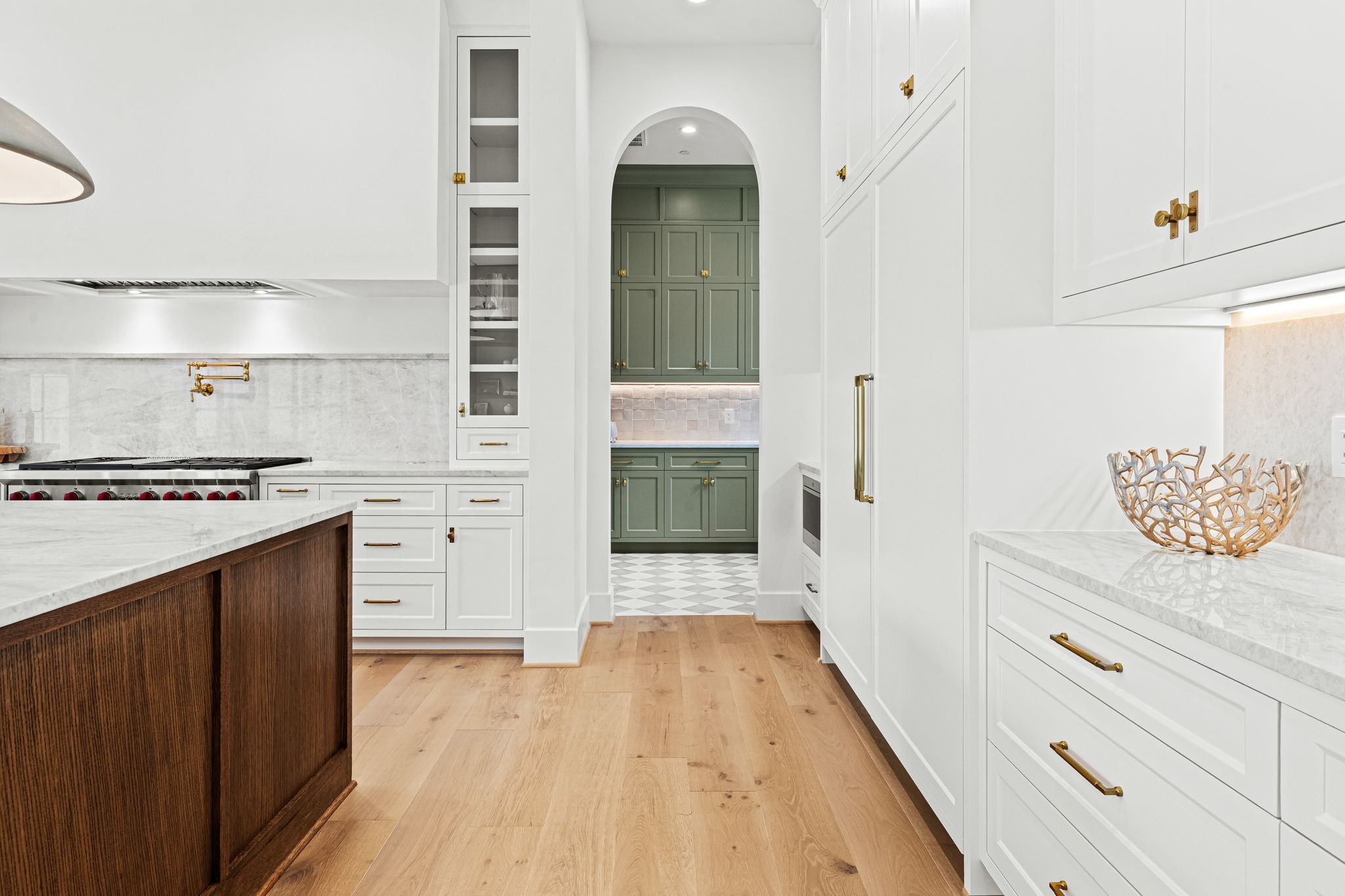 8722 Lupton Lane Houston, TX 77055 - Photo 18 of 44 a hallway with cabinets and wooden floor