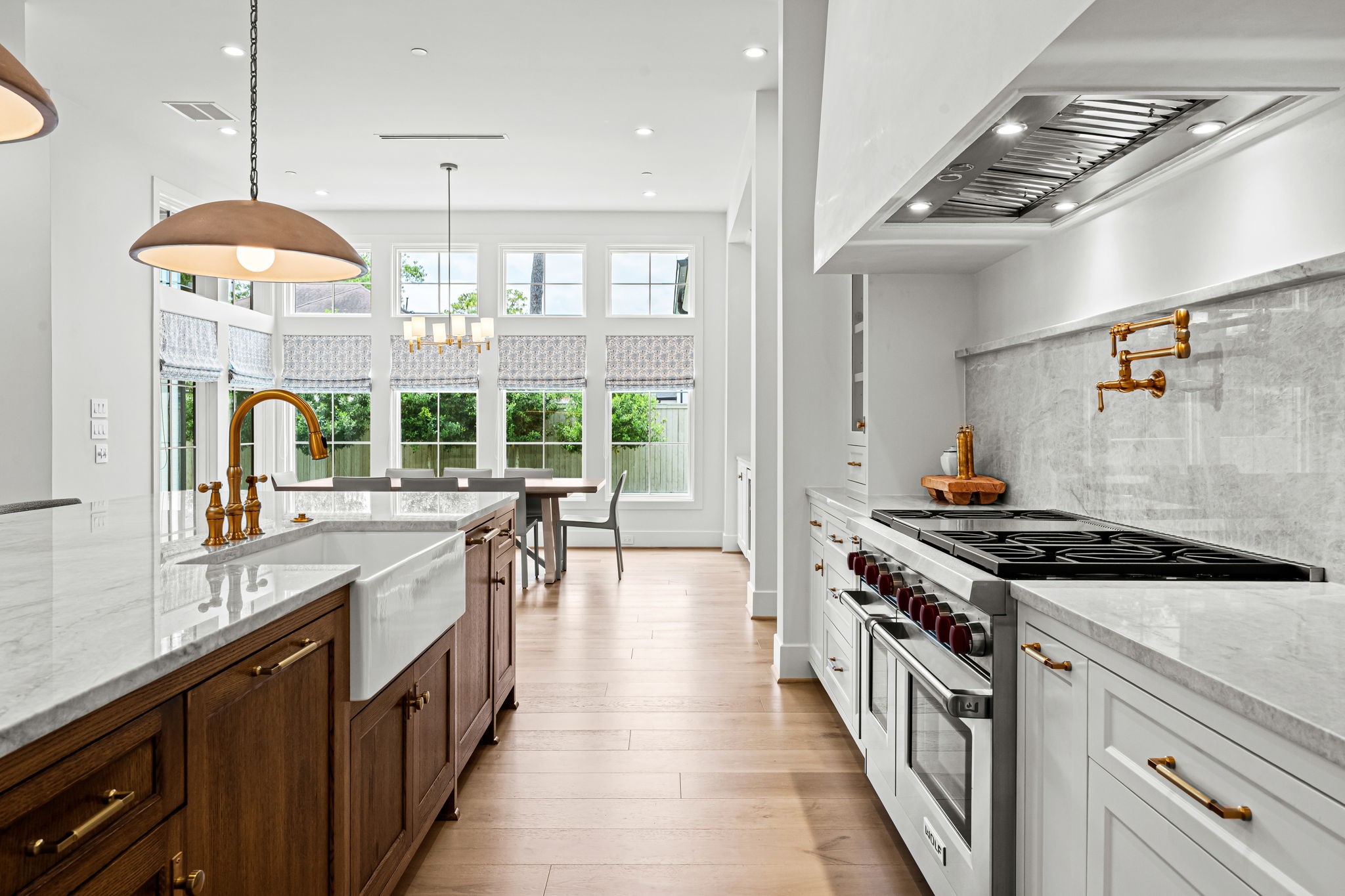 8722 Lupton Lane Houston, TX 77055 - Photo 19 of 44 a kitchen with a stove a chandelier and a sink