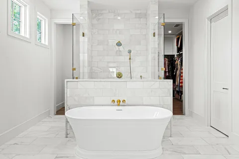 a bathroom with a bathtub and a shower