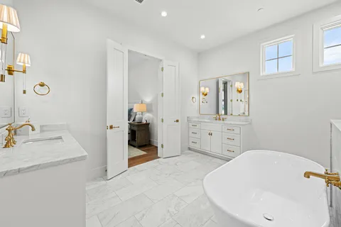 a bathroom with a bathtub sink and mirror