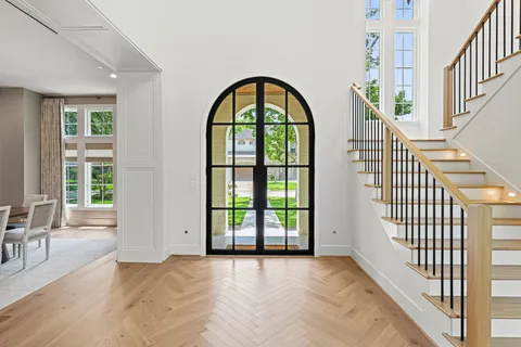 a view of an entryway with wooden floor