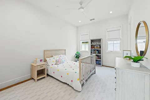 a bedroom with furniture and a book shelf