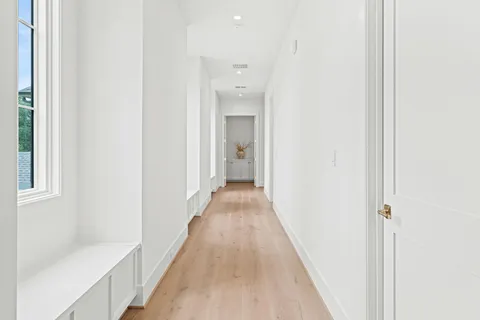 a view of a hallway with wooden floor