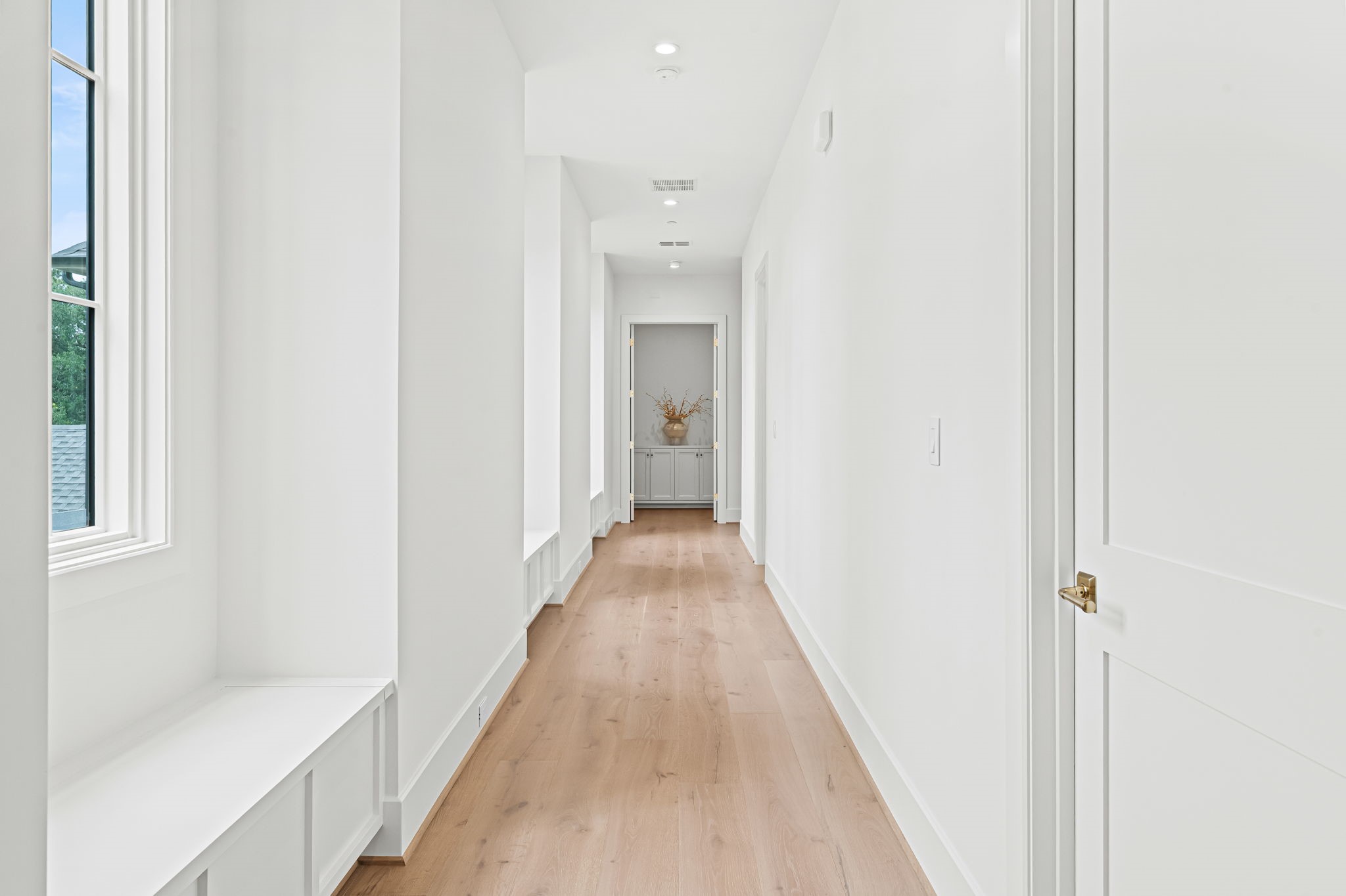 8722 Lupton Lane Houston, TX 77055 - Photo 35 of 44 a view of a hallway with wooden floor