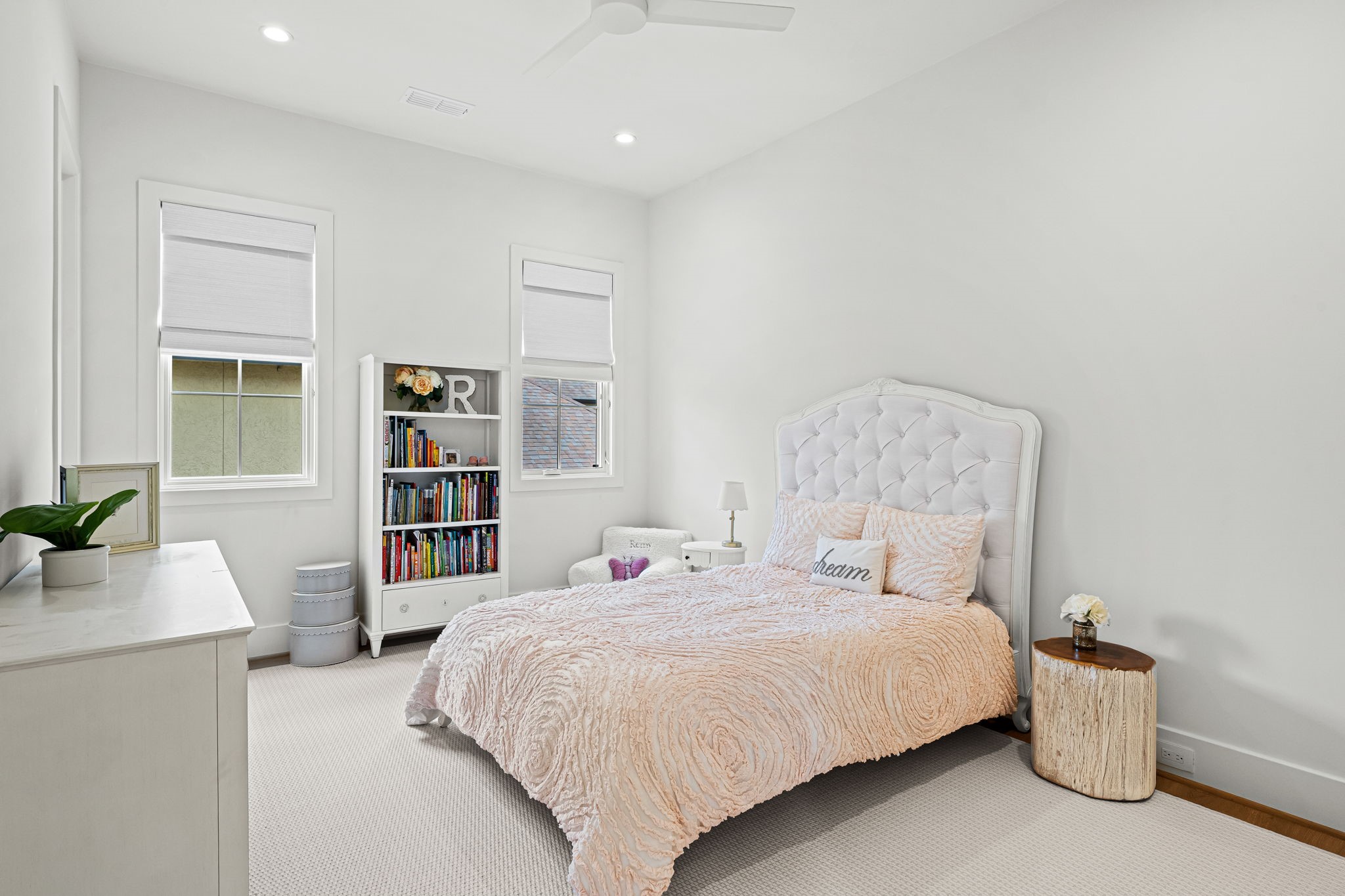 8722 Lupton Lane Houston, TX 77055 - Photo 36 of 44 a bedroom with a bed and a book shelf