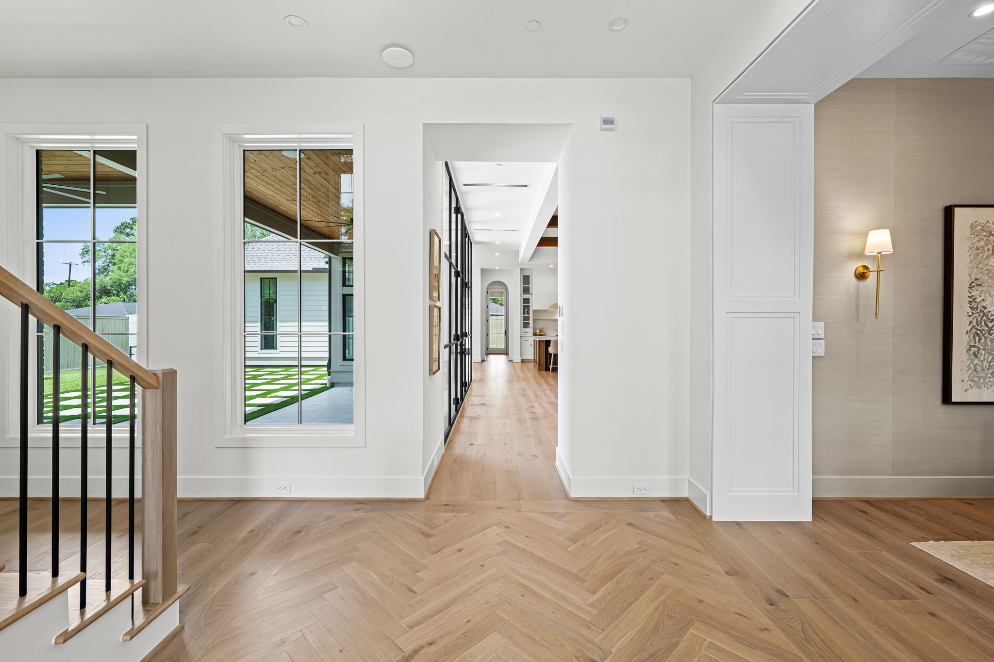 8722 Lupton Lane Houston, TX 77055 - Photo 4 of 44 a view of a hallway with wooden floor and windows