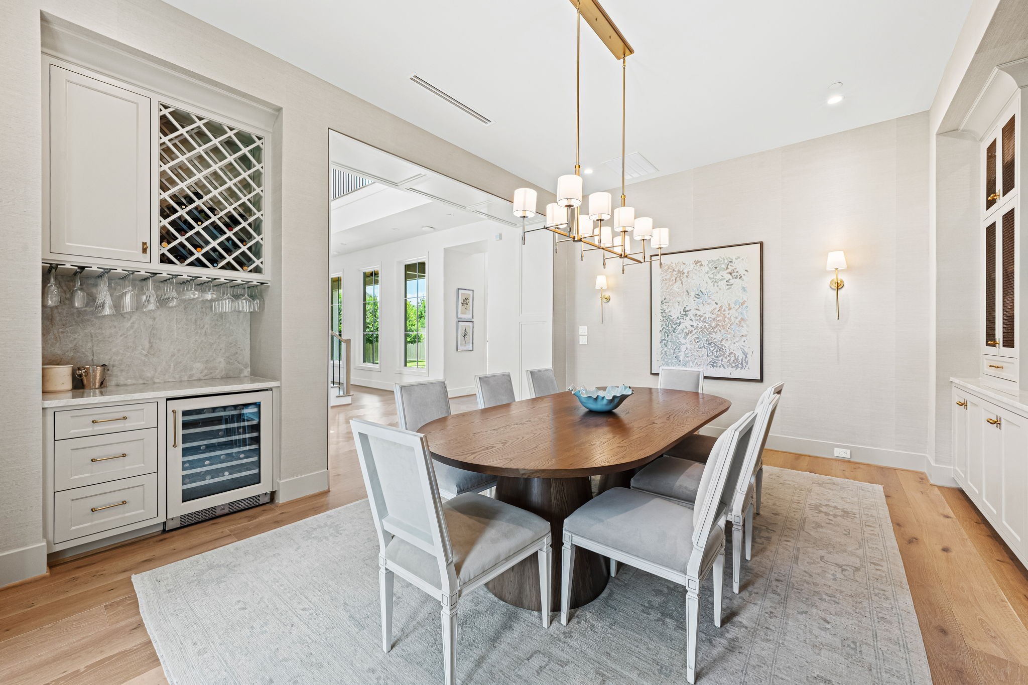 8722 Lupton Lane Houston, TX 77055 - Photo 7 of 44 a dining room with furniture a chandelier and wooden floor