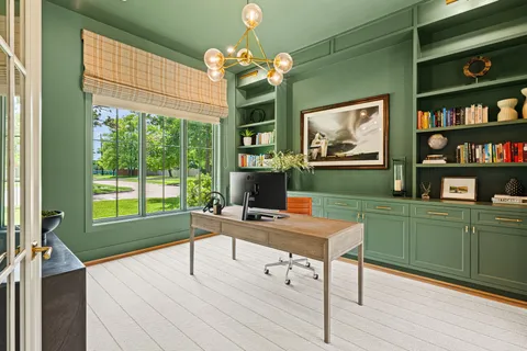 a workspace with wooden floor and a window