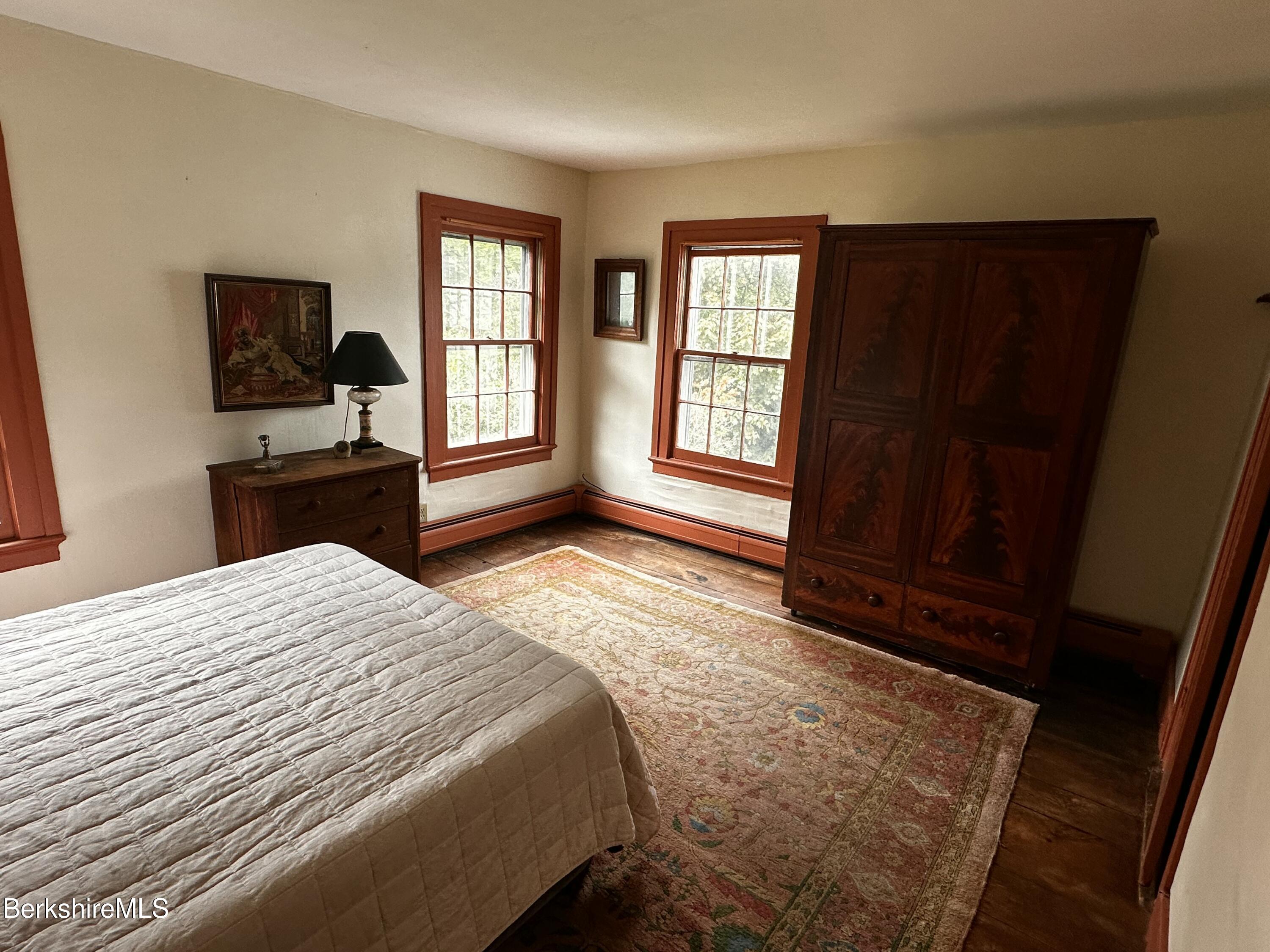 3-5 Swamp Road West Stockbridge, MA 01266 - Photo 16 of 37 a bedroom with a bed and wooden floor