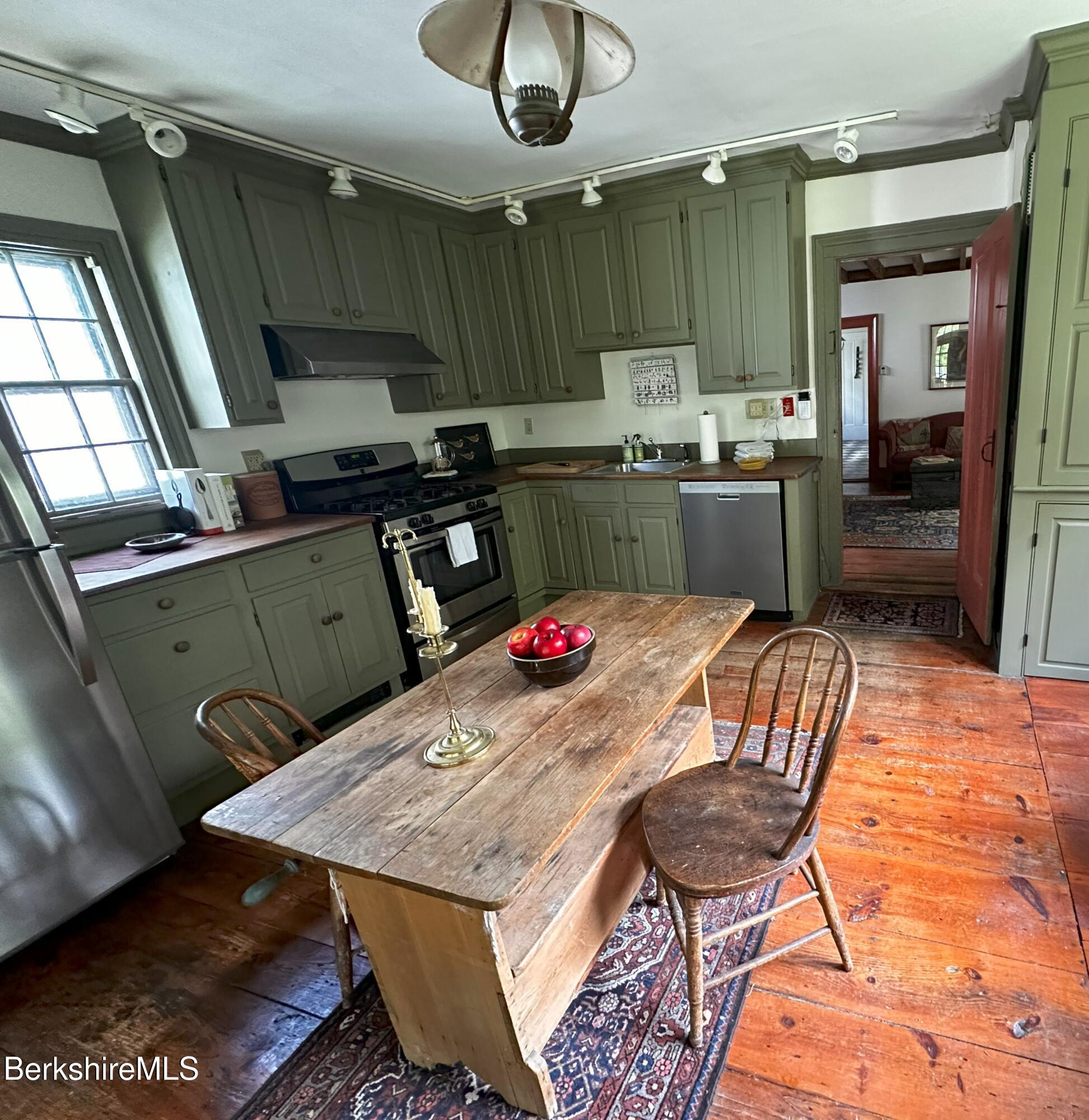 3-5 Swamp Road West Stockbridge, MA 01266 - Photo 7 of 37 a kitchen with a sink a table and chairs