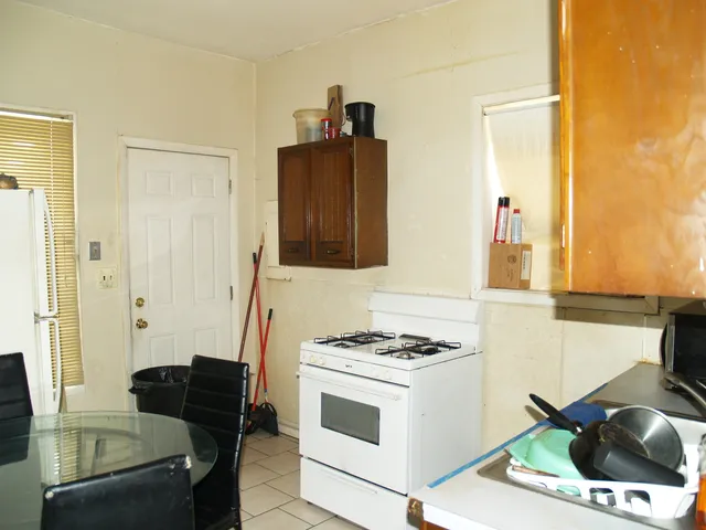 a kitchen with a stove and a refrigerator