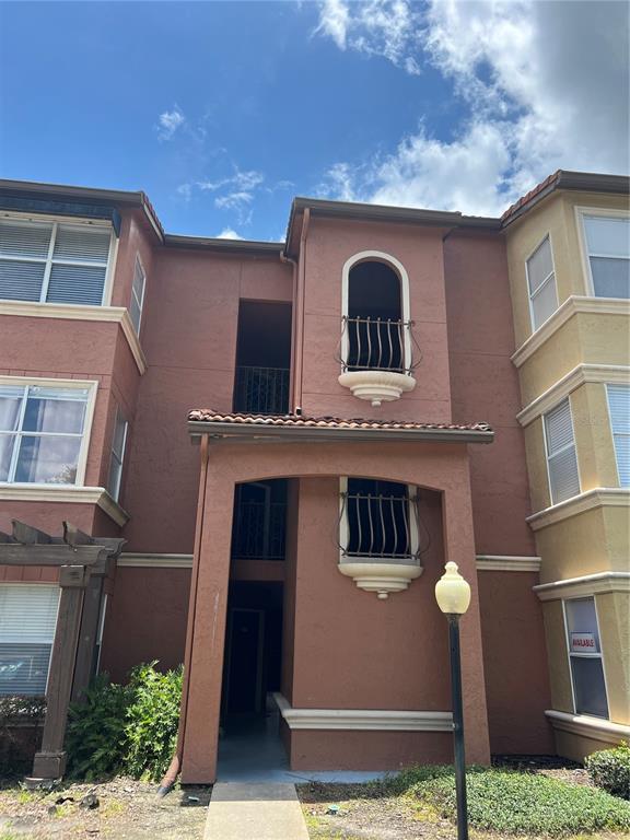 5160 Conroy Road, Unit 34 Orlando, FL 32811 - Photo 1 of 1 a front view of a house with garden