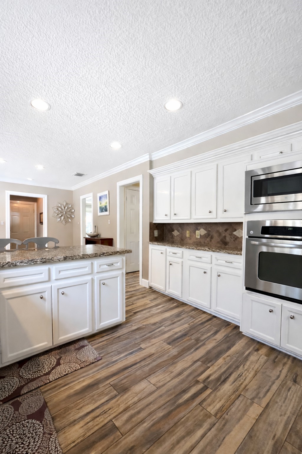 17418 Spicewood Springs Lane Spring, TX 77379 - Photo 10 of 50 a large kitchen with cabinets wooden floor and stainless steel appliances