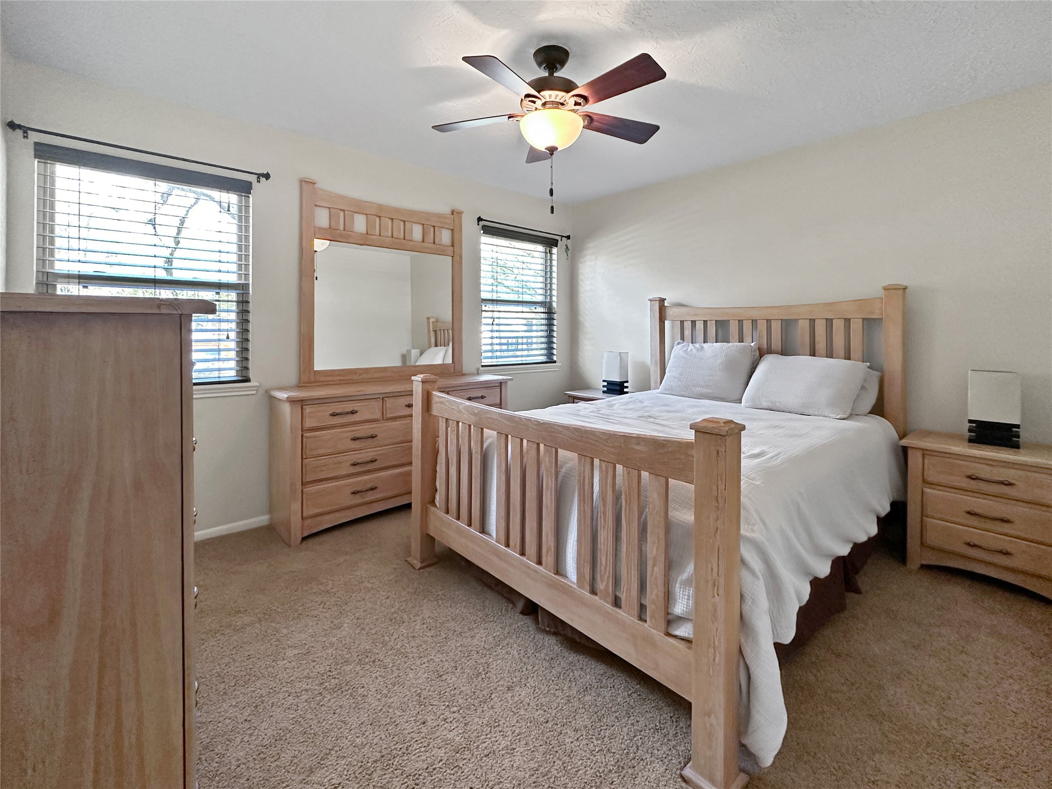 17418 Spicewood Springs Lane Spring, TX 77379 - Photo 16 of 50 a bedroom with a bed dresser and a window