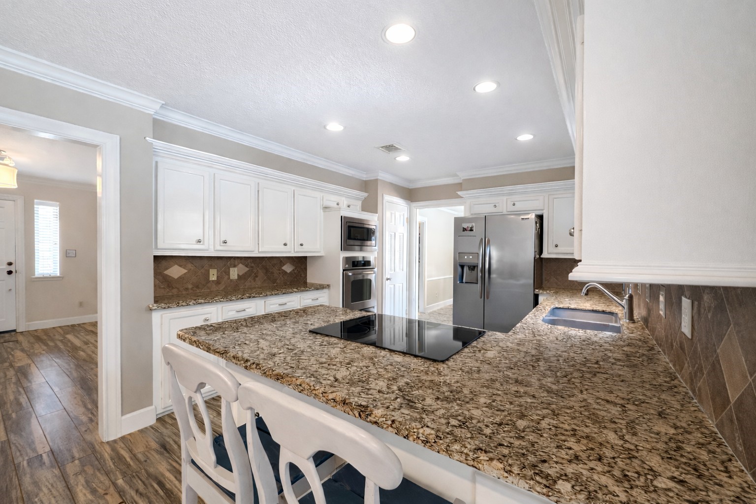 17418 Spicewood Springs Lane Spring, TX 77379 - Photo 9 of 50 a kitchen with stainless steel appliances granite countertop a sink stove and refrigerator