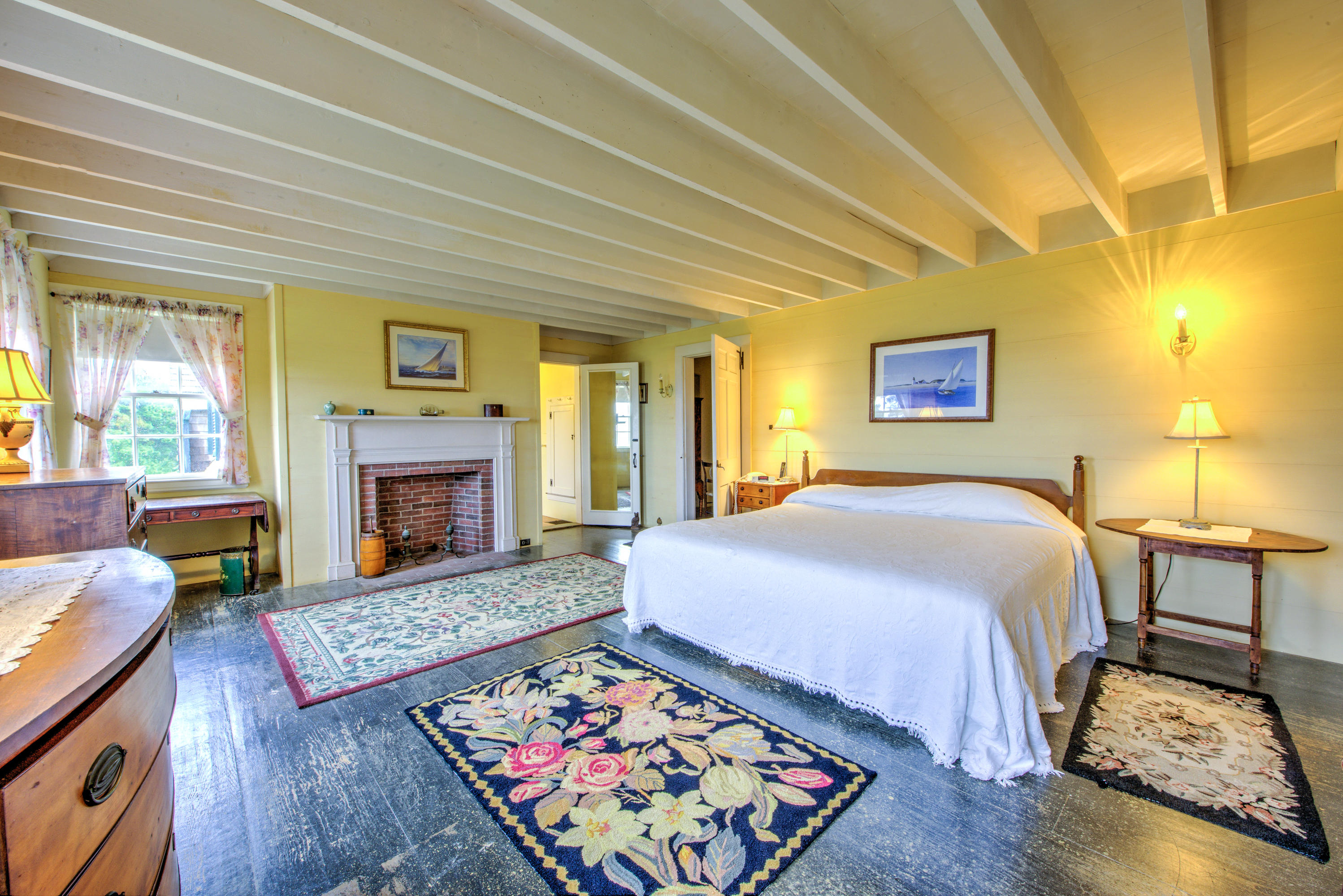 188 Gansett Road Woods Hole, MA 02543 - Photo 16 of 26 a spacious bedroom with a bed and a fireplace