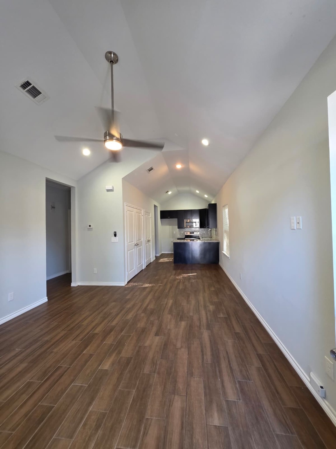 16338 Eastchase Street Montgomery, TX 77316 - Photo 2 of 12 a view of empty room with wooden floor and stove