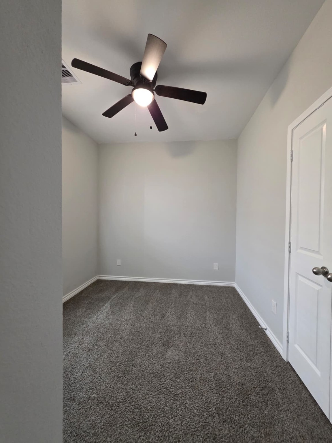 16338 Eastchase Street Montgomery, TX 77316 - Photo 9 of 12 an empty room with a ceiling fan and a window