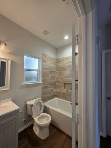 a bathroom with a toilet a sink and bathtub