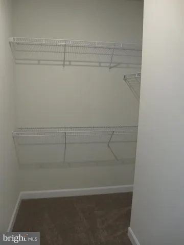 a view of a small space with wooden floor and a window