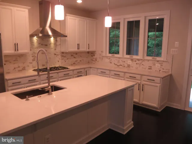 a kitchen with a sink and white cabinets