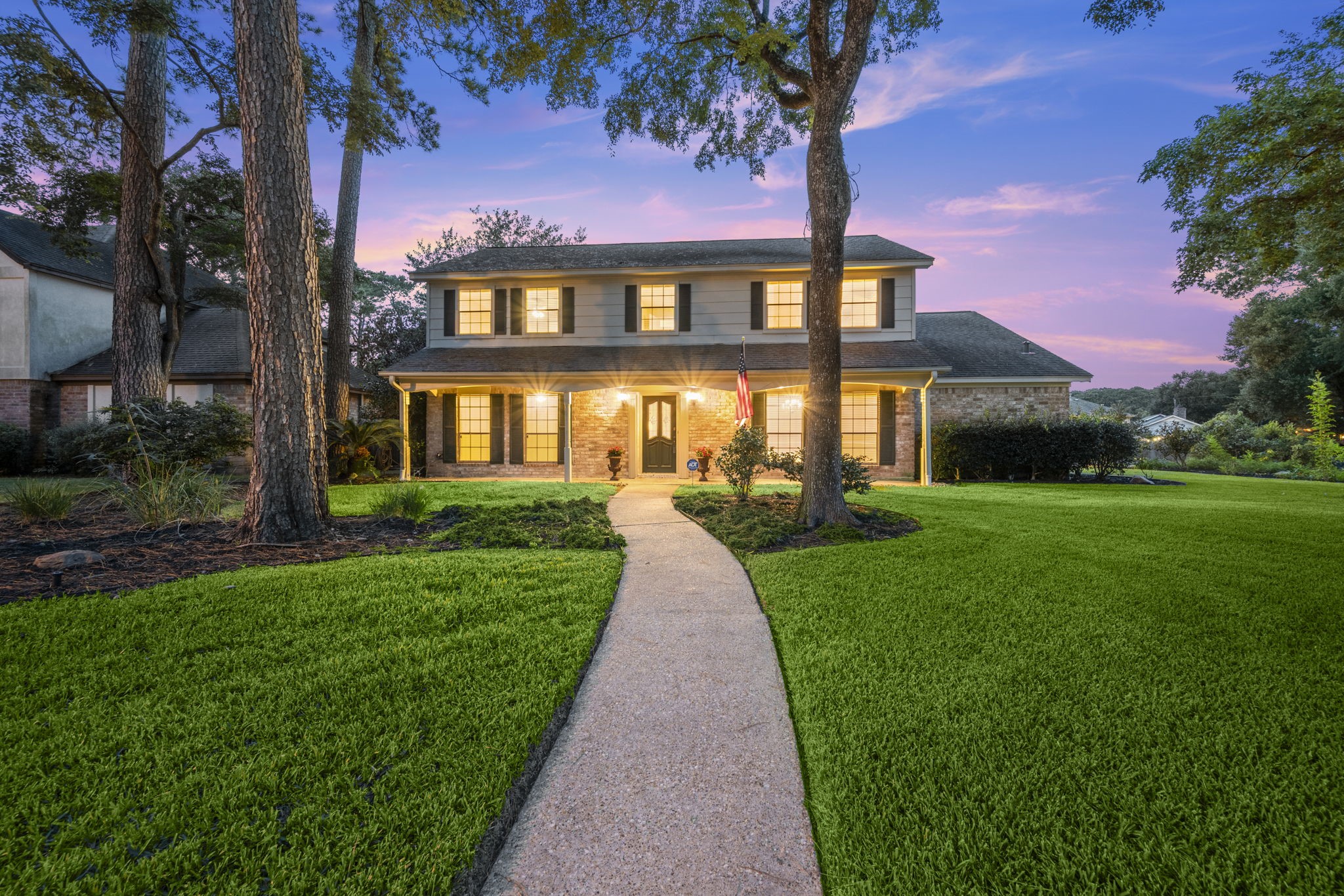 a view of a brick house with a yard