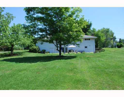 1707 Brodhead Road Coraopolis, PA 15108 - Photo 14 of 16 Yard/Garden. Beautiful park setting with mature trees and privacy. Door to left of patio doors is the room that can be used as a shed to store lawn equipment and patio furniture.
