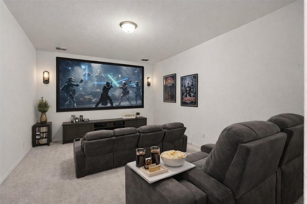 537 Oakmoss Street Little Elm, TX 76227 - Photo 5 of 39 a living room with furniture and a flat screen tv