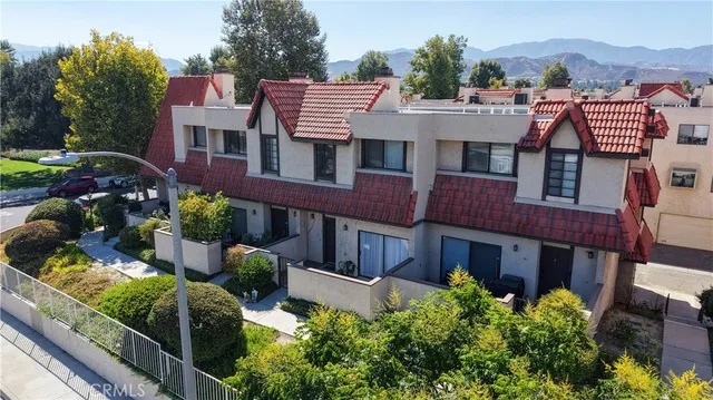 a aerial view of a house with a yard and balcony