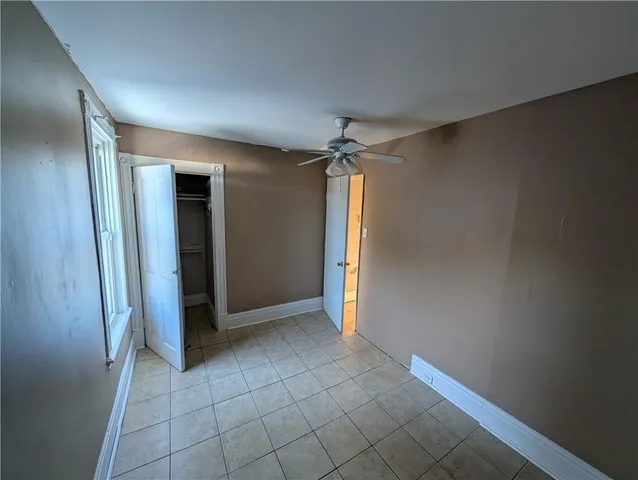 an empty room with closet and a bathroom