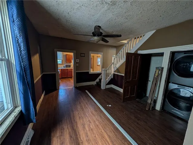 a view of a hallway with wooden floor and stairs
