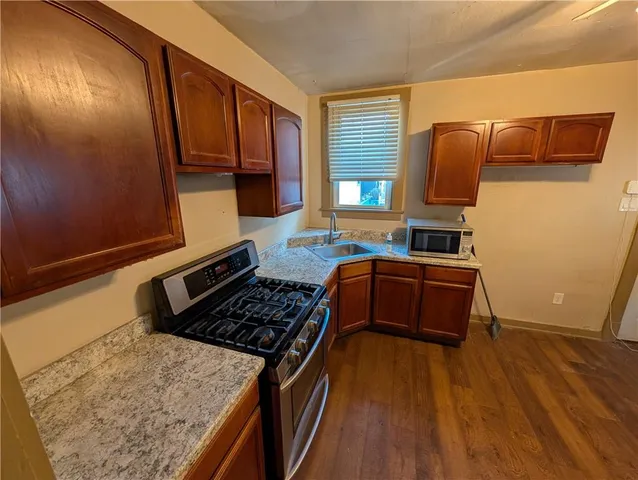 a kitchen with wooden floors and a stove top oven