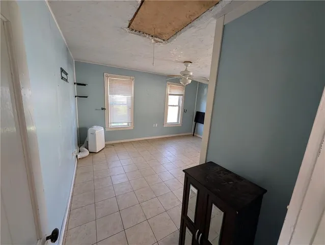 a view of a hallway and wooden floor in a hall