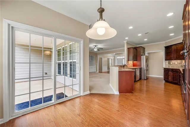 a view of a living room and kitchen with furniture wooden floor kitchen view