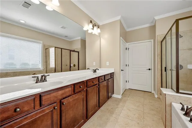 a spacious bathroom with a double vanity sink mirror double and shower