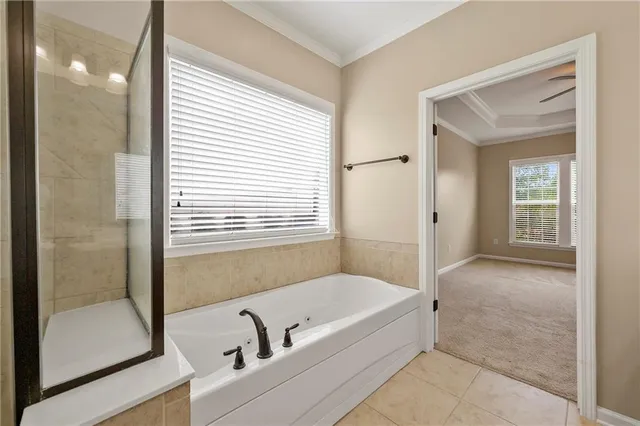 a bathroom with a tub shower and sink