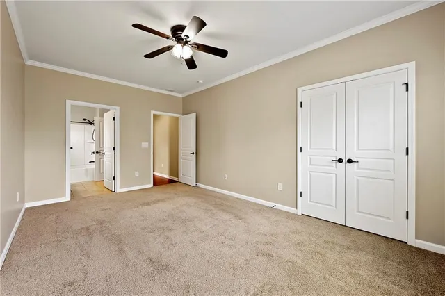 a view of empty room with ceiling fan