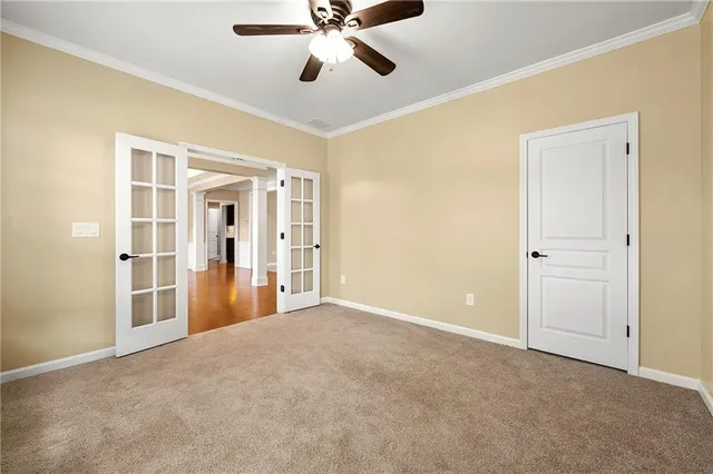 a view of an empty room with a ceiling fan